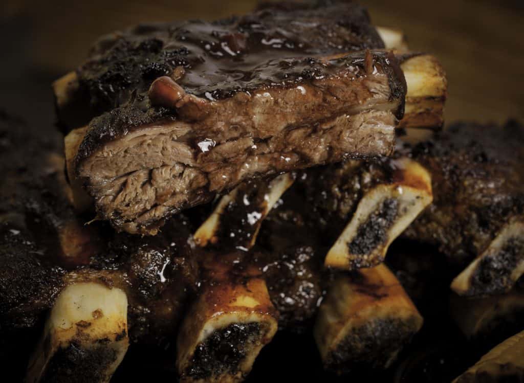 beef ribs being roasted on the barbeque