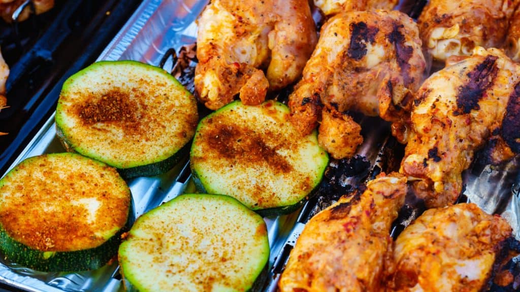 delicious chicken meat and zucchini vegetable on barbecue gas grill