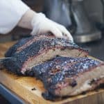 Large Piece Of Smoked Brisket Meat On A Wooden Board