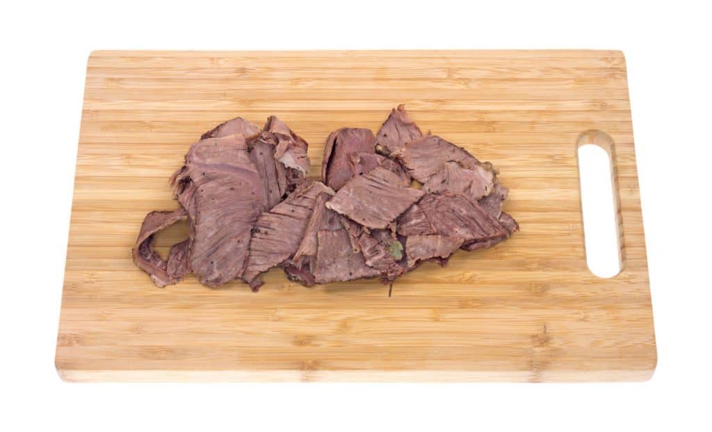 thin sliced chuck roast on cutting board