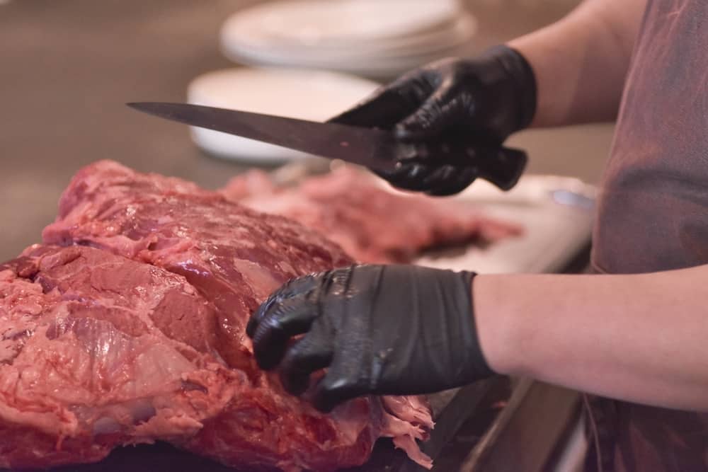Butcher Slicing Beef