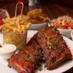 Delicious Ribs With Sides And Sauces