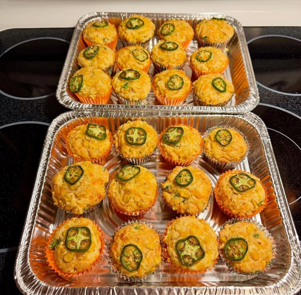 Cheddar jalapeño cornbread muffins in foil trays.