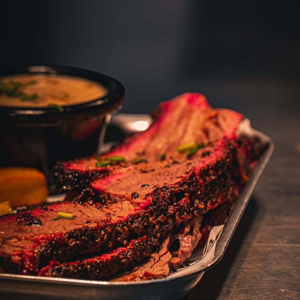 Smoked beef brisket slices with barbecue seasoning.