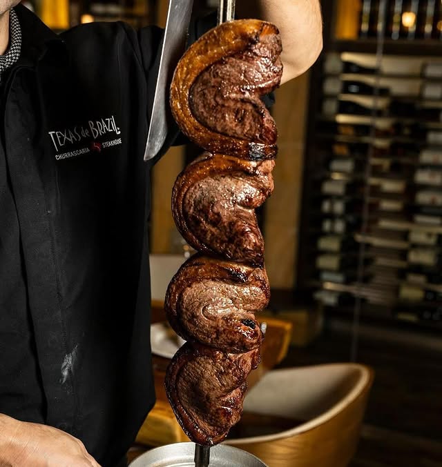 A Pitmaster Holding A Picanha Skewer