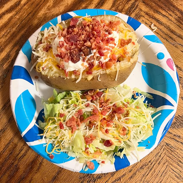 loaded baked potatoes with a side salad