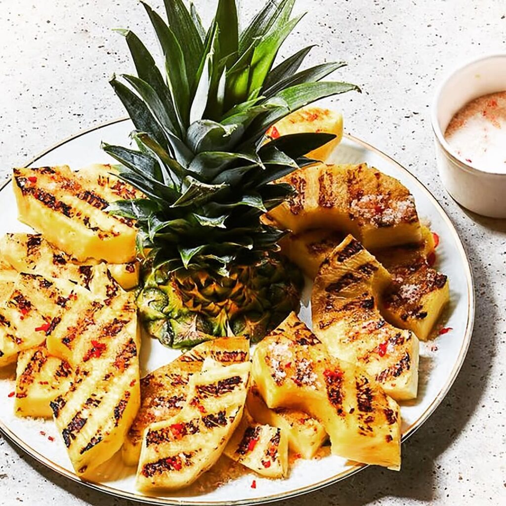 Sizzle By The Shore: How To Throw A Beach Bbq Party Everyone Will Love 10 Grilled Pineapple On A Dinner Plate