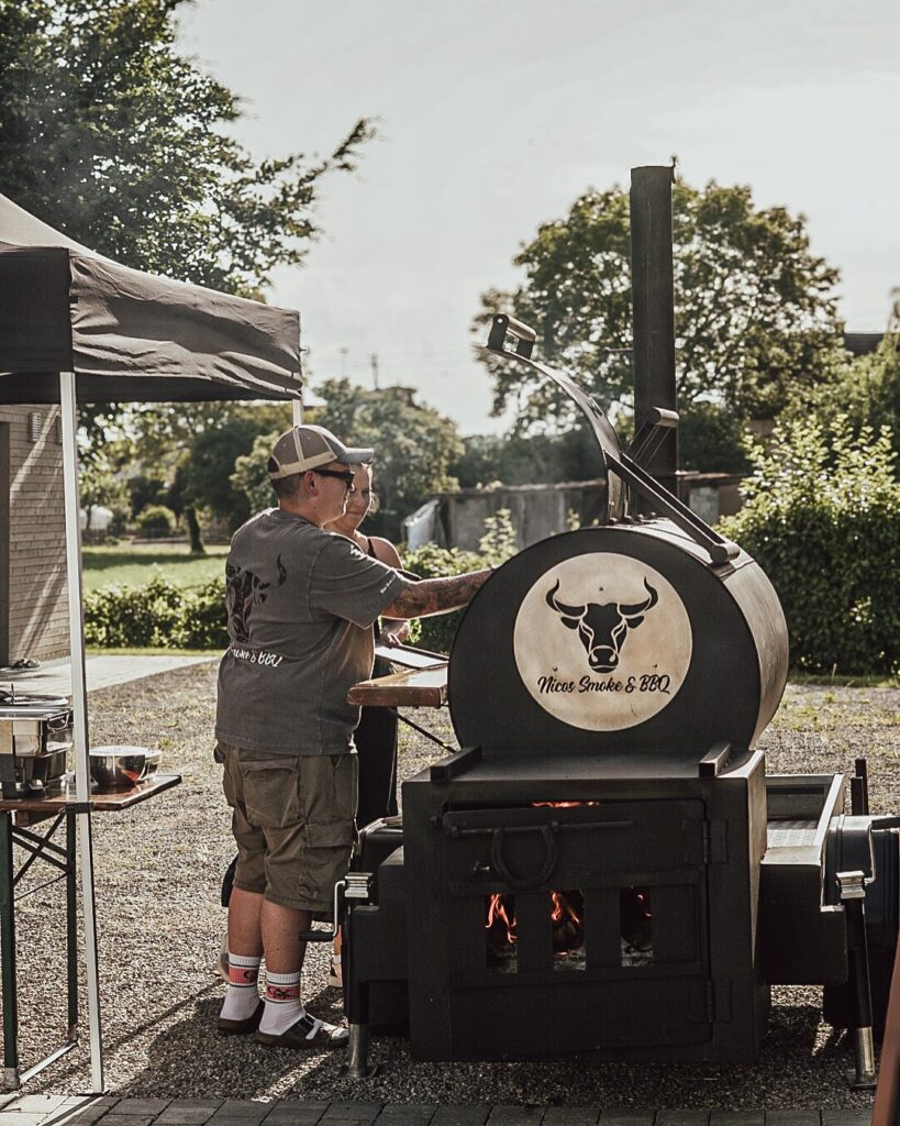 Man Checking A Bbq Smoker