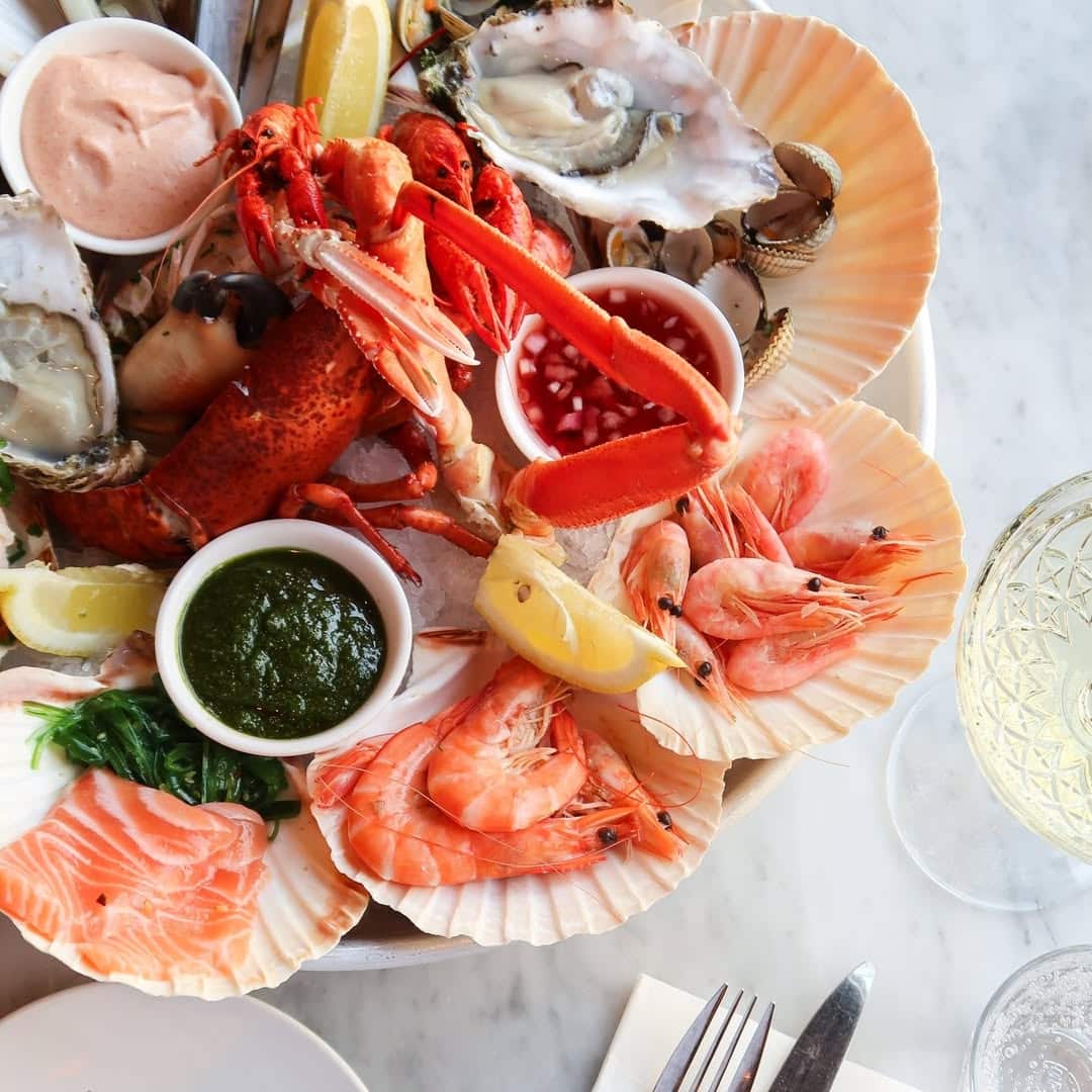 seafood sides veggies and citrus in a platter