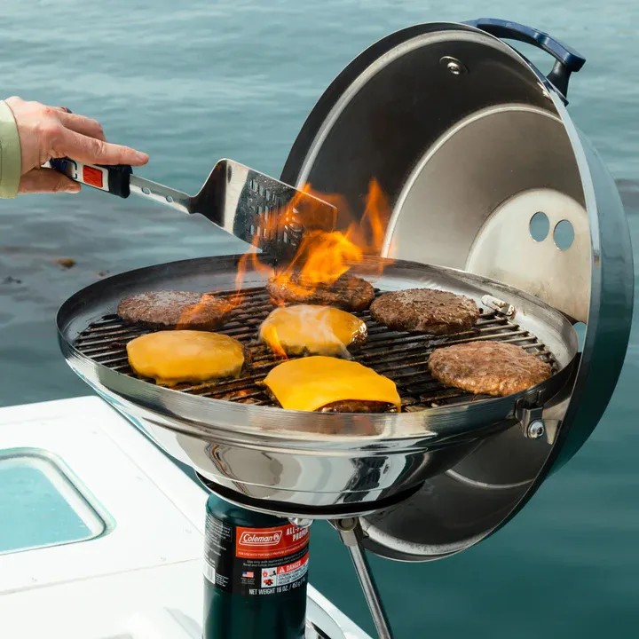Rounded Charcoal Grill On The Side Of A Boat