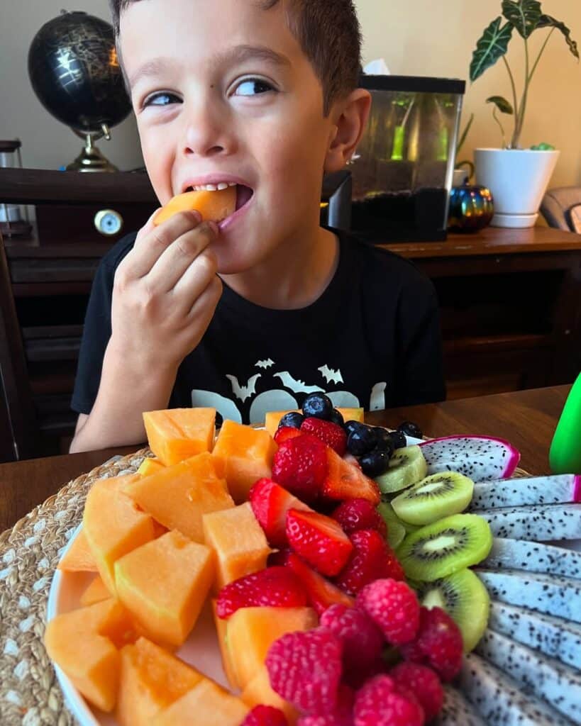 A Child Eating Grilled Fruits