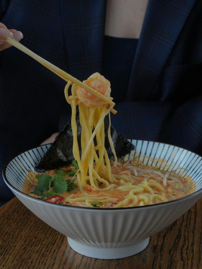 Comforting Creamy Shrimp Soup New Year Recipe For Winter Nights 3 Woman In Business Suit Eating Shrimp Soup Noodles