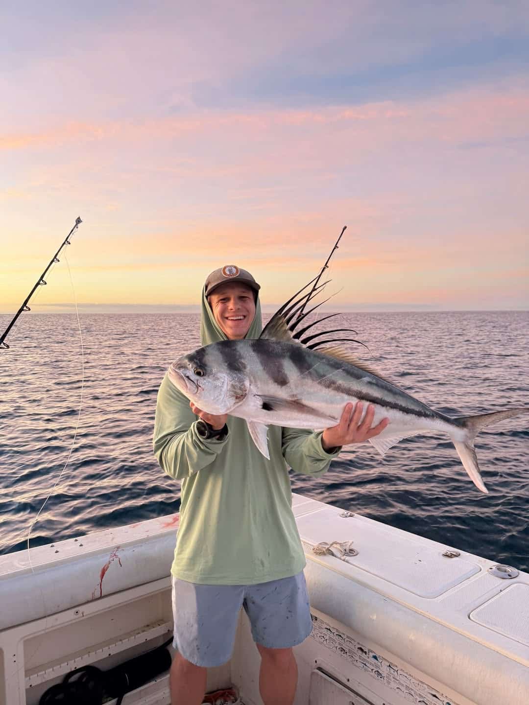 man poses for his deep sea catch
