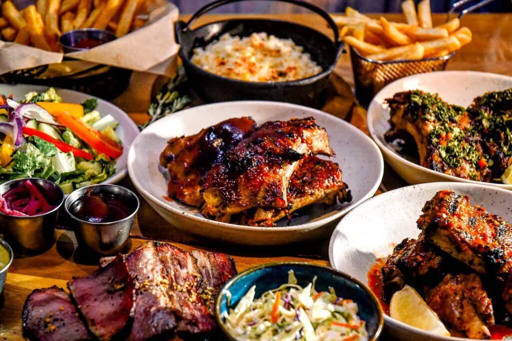 Charred Bbq With Veggies Sides Sauces Dips And French Fries