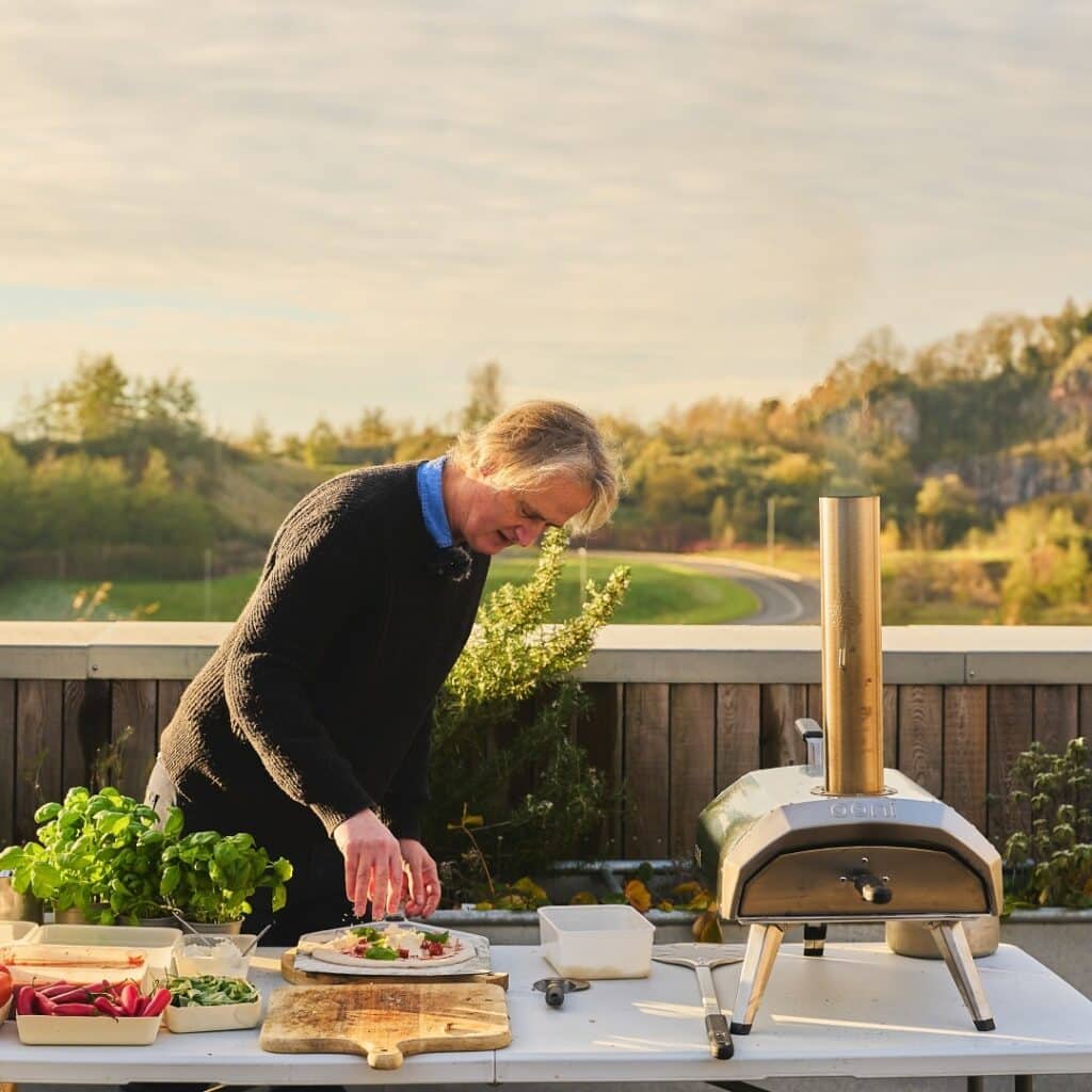 Crust Goals: Level Up Your Pizza Game With These 10 Best Ooni Pizza Grills 12 Man Grilling Pizza In An Ooni Pizza Grill