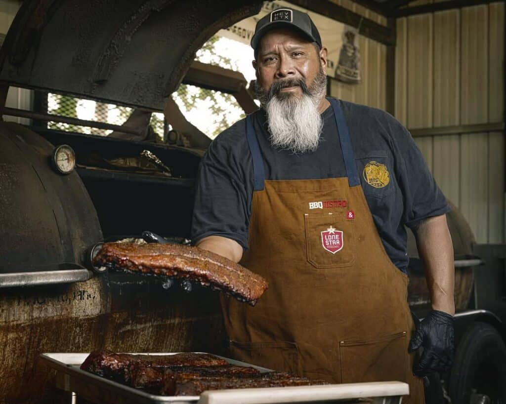 A Pitmaster Shows Off His Well Cooked Pork Ribs