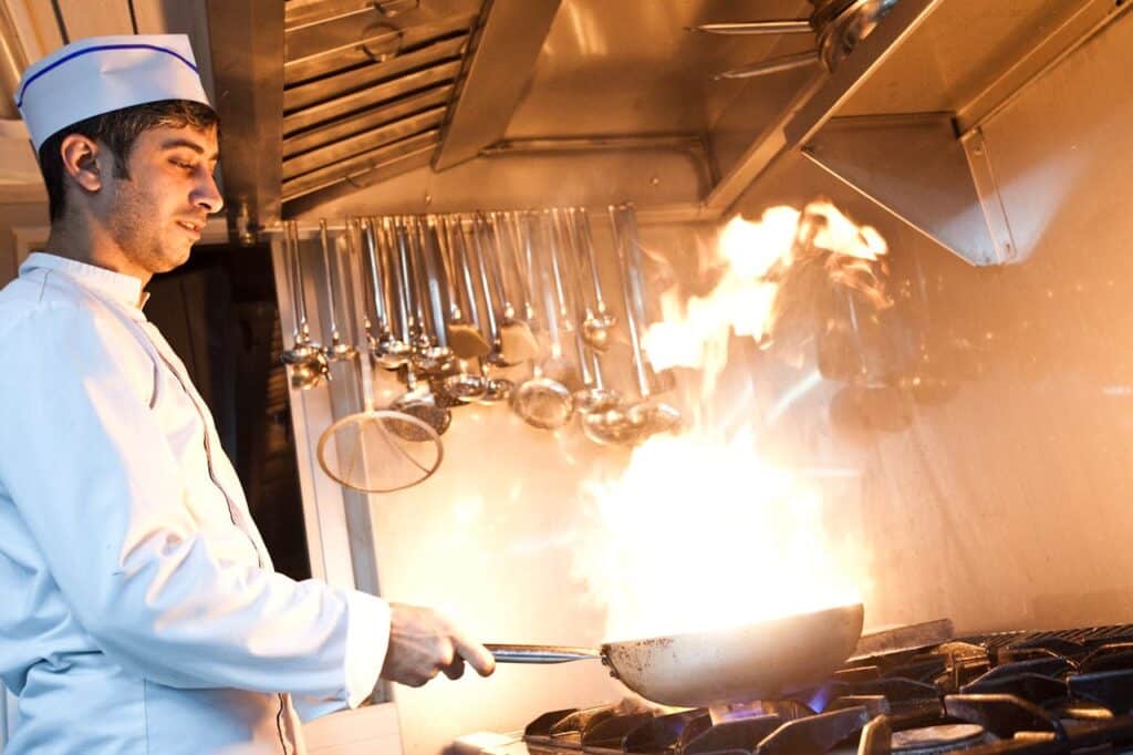 Cozy And Sumptuous Beef And Cabbage Stir Fry At Home 2 Chef Cooking With Frying Pan In Flames
