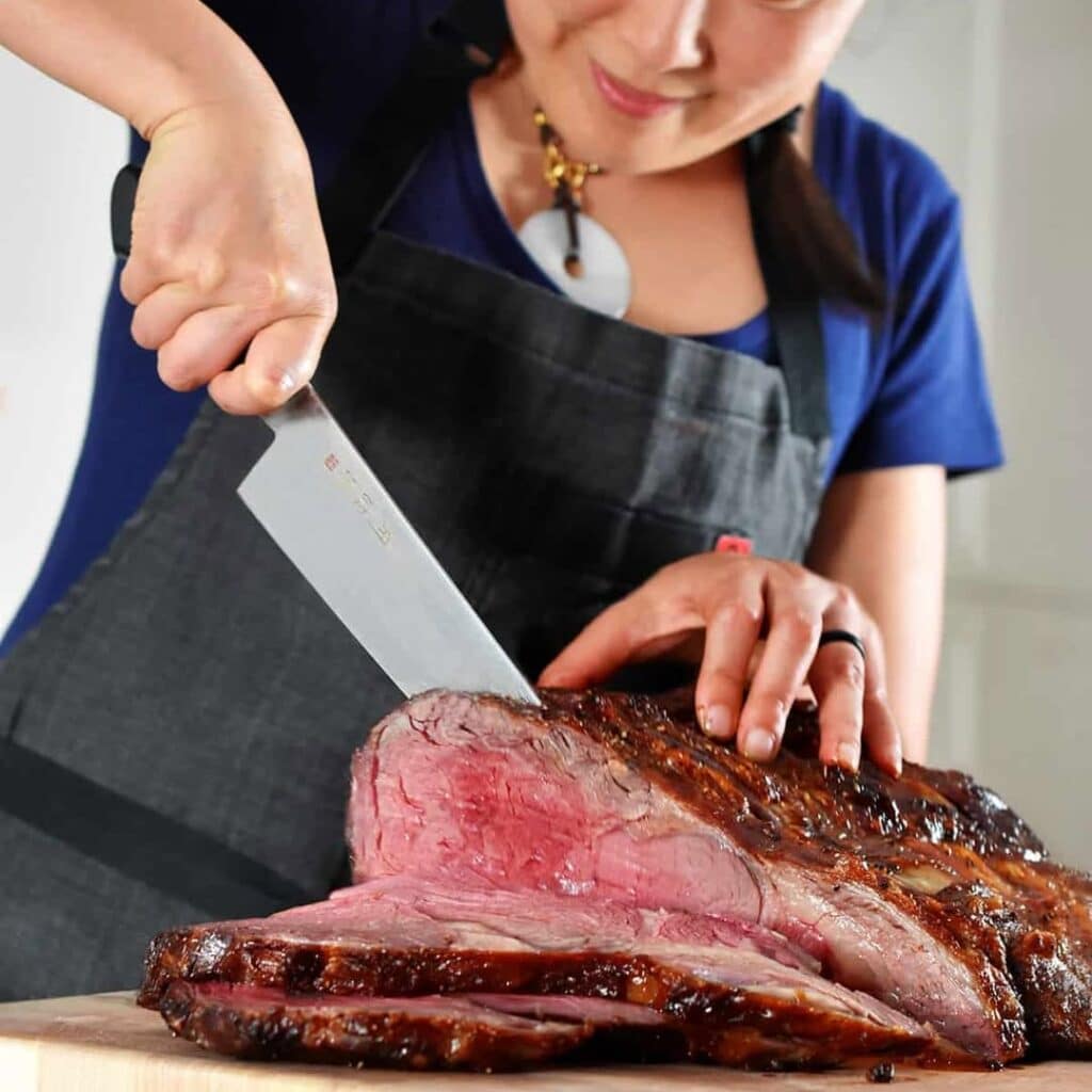 Female Chef Slices Prime Rib