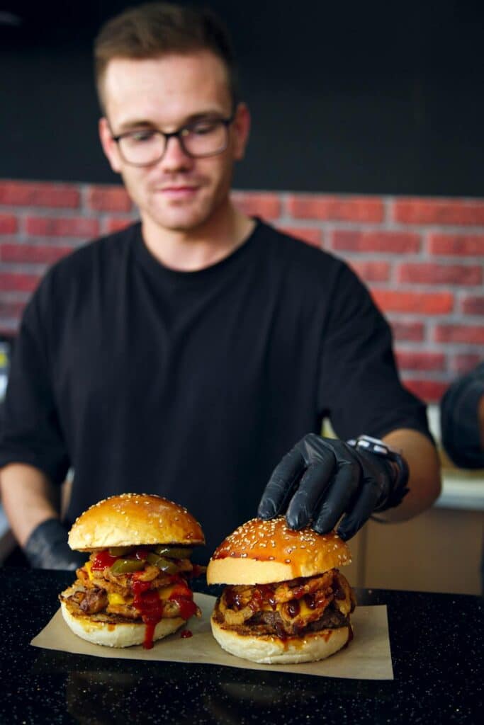 Man Arranging Burgers