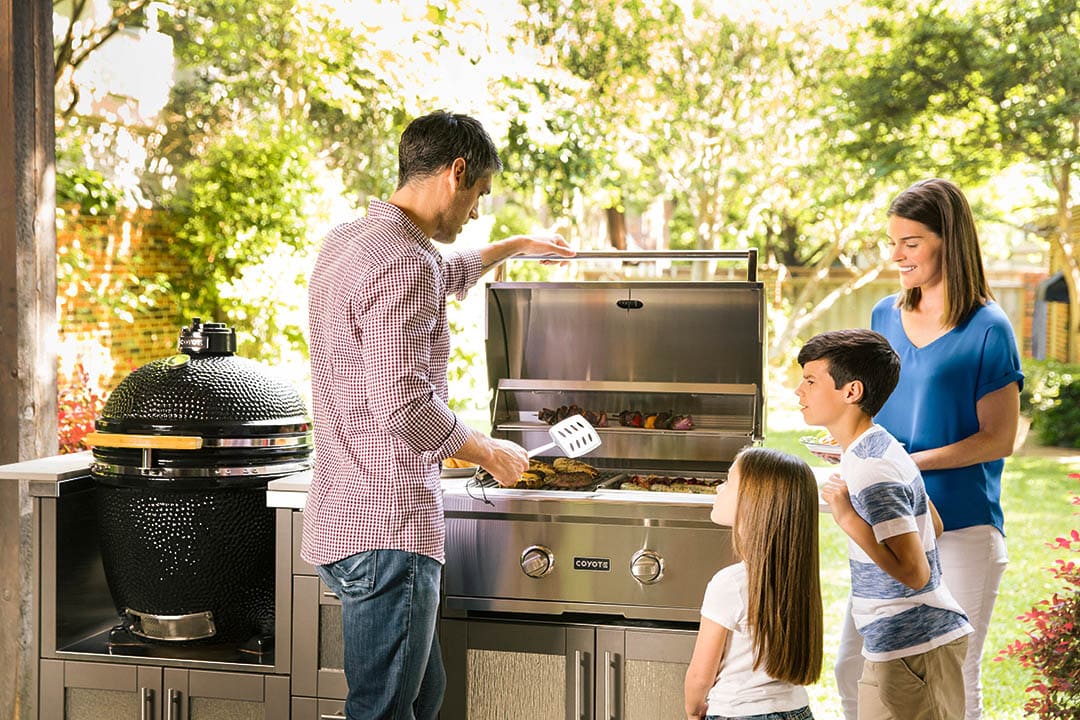 man grills food as his family watches