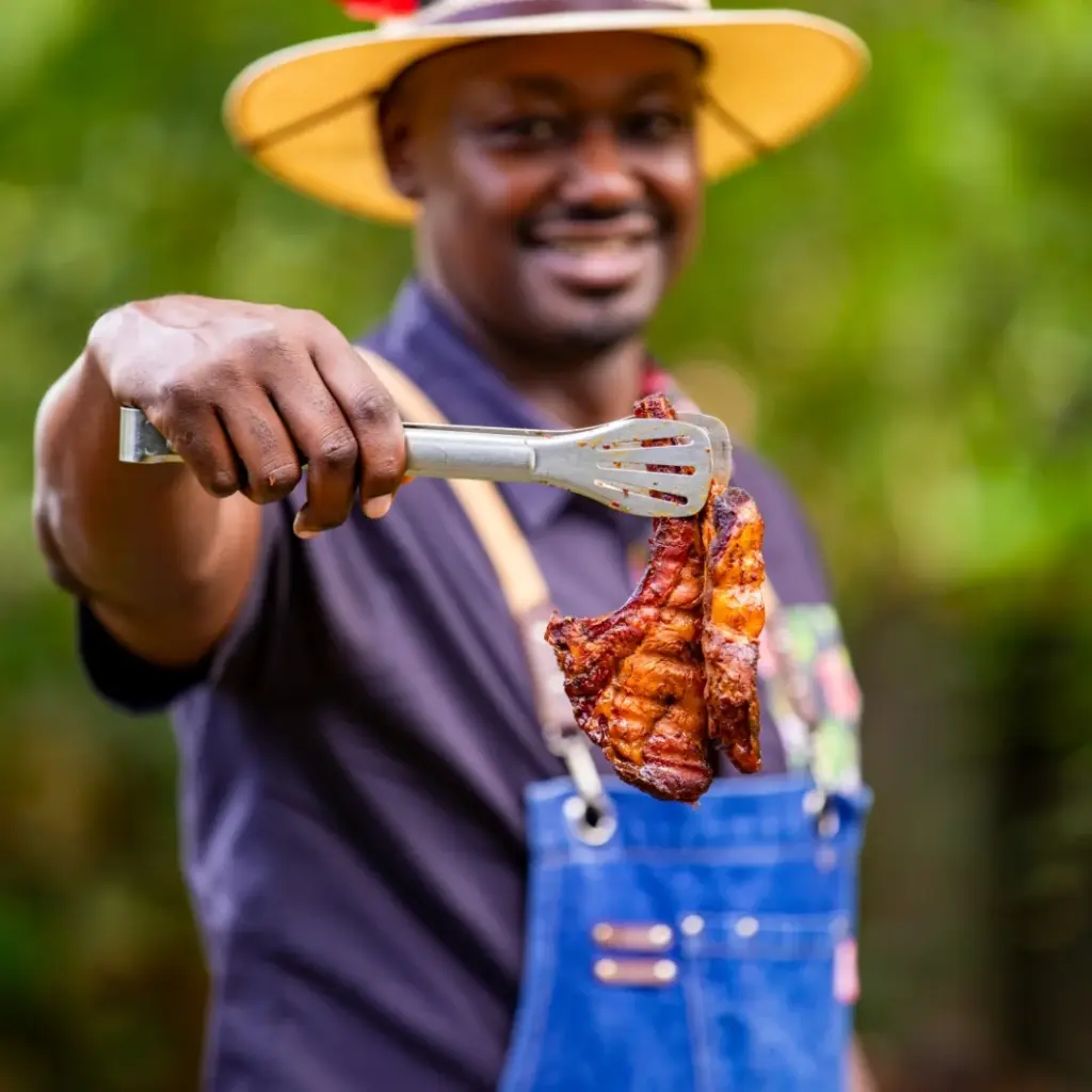 What Professional Pitmasters Eat When They’re Not Cooking Bbq 1 Pitmaster Holding A Bbq On A Pair Of Tongs