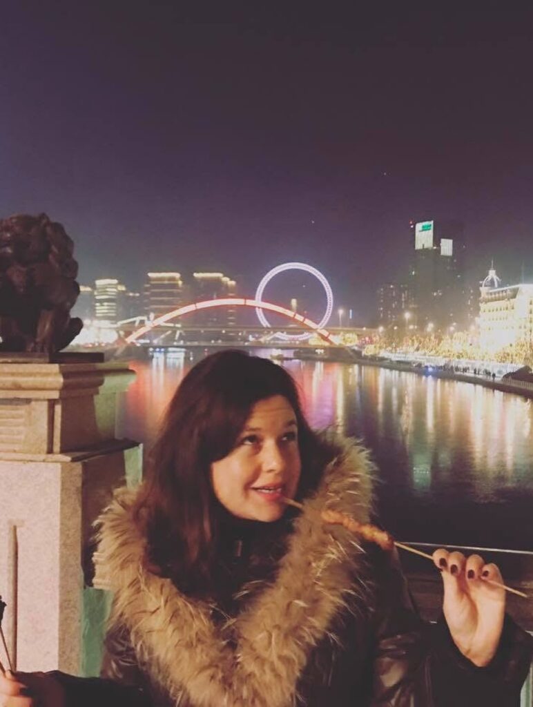 A Tourist Eating Chinese Chuan’r Lamb Skewers At Night