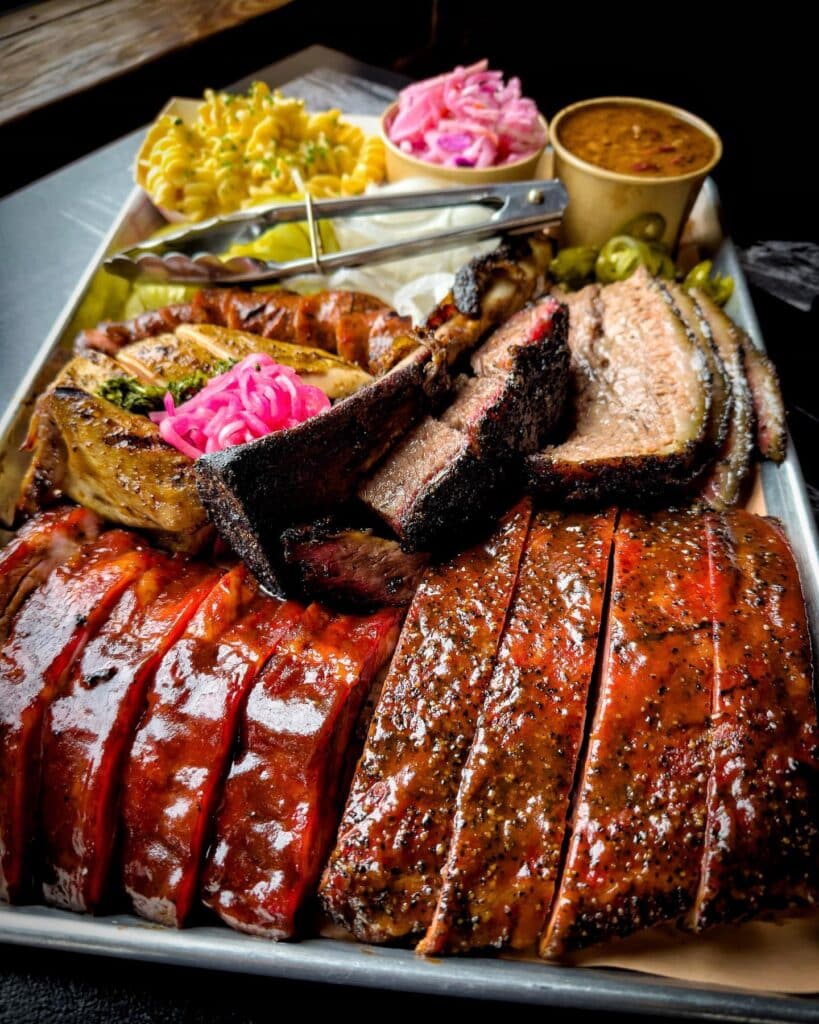 The Real Difference Between Grilling, Smoking, And Barbecuing 5 A Big Tray Of Bbq Food Served