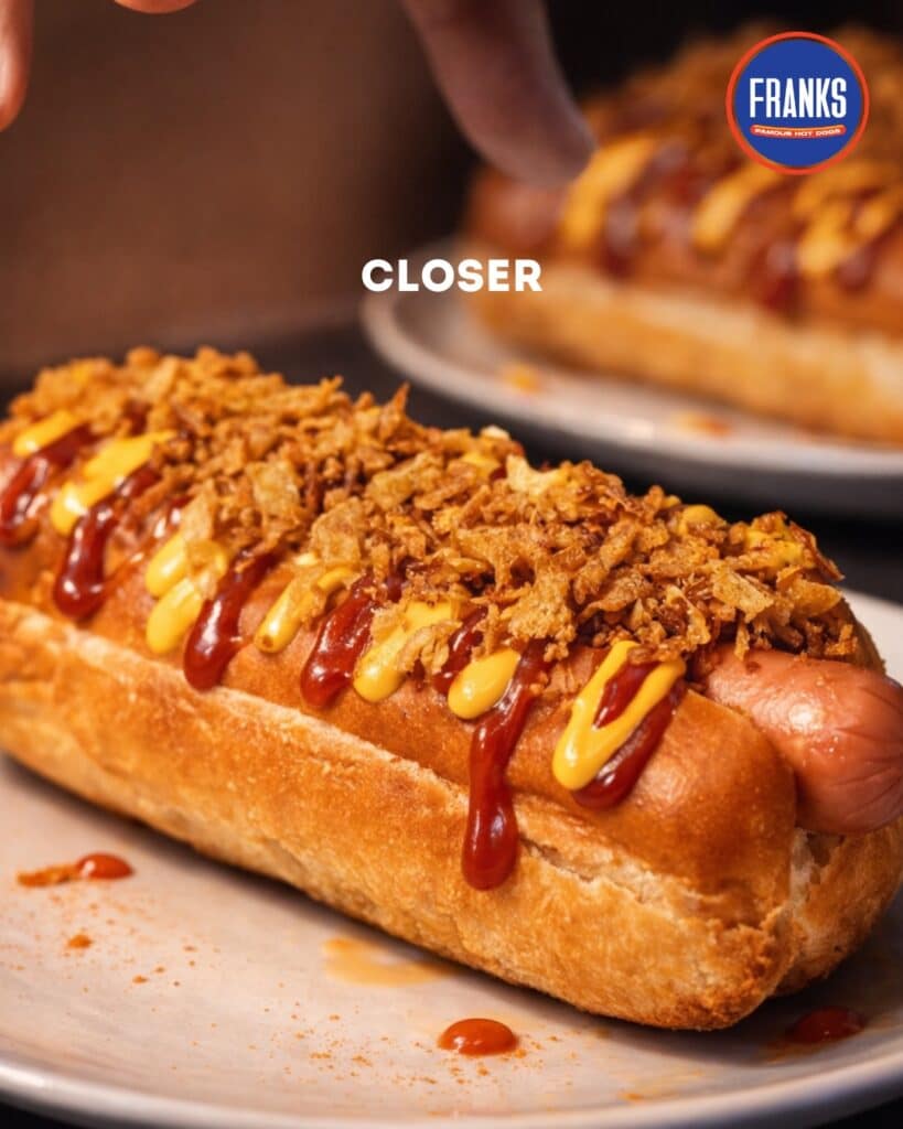 The Seattle-Style Hot Dog: Elevating Game-Day Comfort Food With Cream Cheese And Onions 3 Fused Bun Hot Dog With Fried Garlic Ketchup And Mayo Toppings