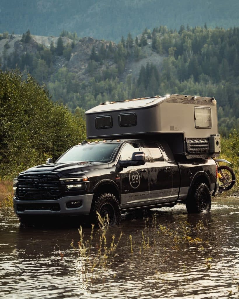 A Camping Truck Parked Near A River