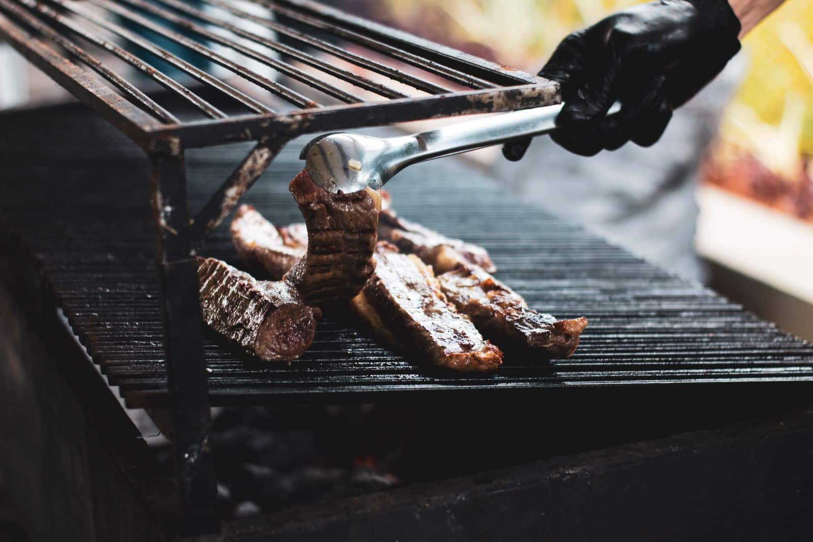 Grill Master Challenge - Cook Grilling Beef Over A Charcoal Barbecue With Tongs
